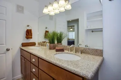 a bathroom with two sinks and a large mirror at 6Br Duplex W Oceanview Patios, Steps To 40Th Street Beach By Beachview Rentals in Newport Beach