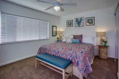 a bedroom with a bed and a ceiling fan at 6Br Duplex W Oceanview Patios, Steps To 40Th Street Beach By Beachview Rentals in Newport Beach
