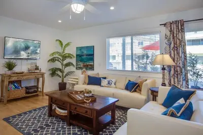 a living room with a couch and a table at 6Br Duplex W Oceanview Patios, Steps To 40Th Street Beach By Beachview Rentals in Newport Beach