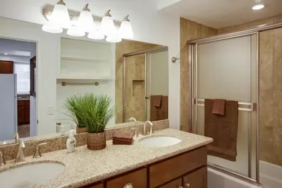 a bathroom with two sinks and a shower at Ultimate Coastal Retreat Seconds From Sand W Oceanviews By Beachview Rentals in Newport Beach