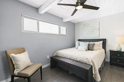 a bedroom with a bed and a ceiling fan at Modern 4Br Vacation Home W Ocean Views And Rooftop Deck By Beachview Rentals in Newport Beach