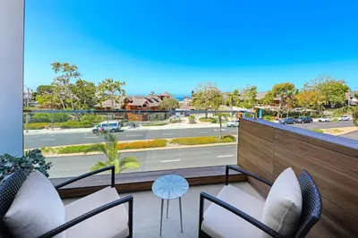 a balcony with chairs and a view of a street at Luxury Stay Corona del Mar, Short Walk to Beach in Newport Beach