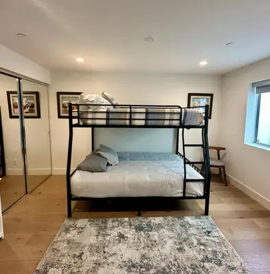 two bunk beds in a room with a rug at Luxury Stay Corona del Mar, Short Walk to Beach in Newport Beach