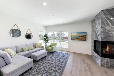 a living room with a couch and a fireplace at Luxury Stay Corona del Mar, Short Walk to Beach in Newport Beach