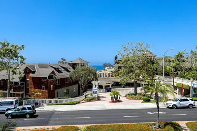 a street with cars parked on a street with houses at Luxury Stay Corona del Mar, Short Walk to Beach in Newport Beach