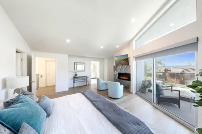 a living room with a bed and a fireplace at Luxury Stay Corona del Mar, Short Walk to Beach in Newport Beach