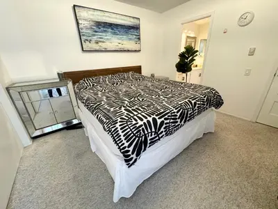 a bedroom with a bed with a black and white comforter at Amazing house in La Jolla in San Diego