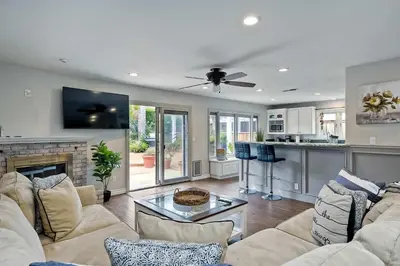 a living room with a couch and a fireplace at Carlsbad Charm - 3BR Stunner in Carlsbad