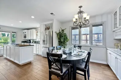 a kitchen and dining room with a table and chairs at Carlsbad Charm - 3BR Stunner in Carlsbad