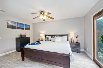 a bedroom with a bed and a ceiling fan at Carlsbad Charm - 3BR Stunner in Carlsbad