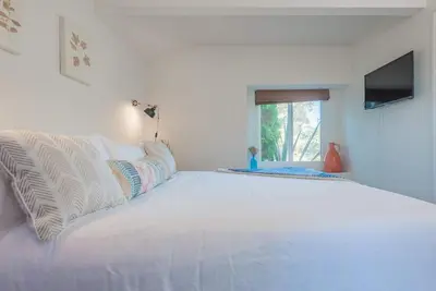 a white bed in a room with a window at Family Retreat - Legoland & Beach in Oceanside