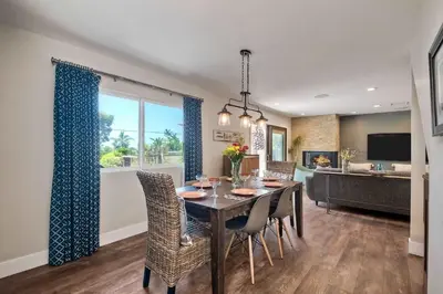 a dining room with a table and chairs and a kitchen at Fresh & Modern 3BR - Just Blocks from Beach in Encinitas