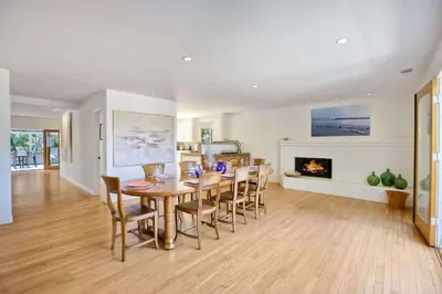 a dining room with a table and chairs and a fireplace at Serene Coastal Home Sleeps 8 - 1 Mile from Beach in Encinitas