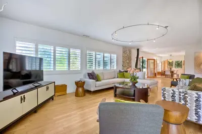 a living room with a couch and a tv at Serene Coastal Home Sleeps 8 - 1 Mile from Beach in Encinitas