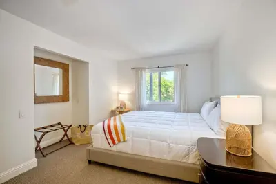 a bedroom with a large bed and a window at Serene Coastal Home Sleeps 8 - 1 Mile from Beach in Encinitas