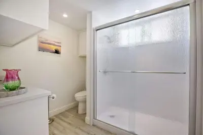 a glass shower in a bathroom with a toilet at Serene Coastal Home Sleeps 8 - 1 Mile from Beach in Encinitas