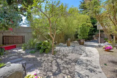a garden with a tree and a pathway at Serene Coastal Home Sleeps 8 - 1 Mile from Beach in Encinitas