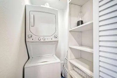 a white laundry room with a washer and dryer at La Costa Gem - Condo for 3 in Carlsbad