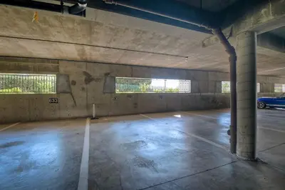 an empty parking garage with a car parked in it at La Costa Gem - Condo for 3 in Carlsbad