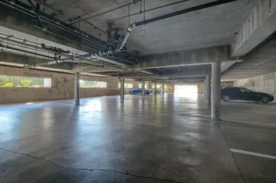 an empty parking garage with cars parked in it at La Costa Gem - Condo for 3 in Carlsbad