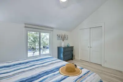 a bedroom with a bed with a hat on it at Seaside Sunset in Carlsbad