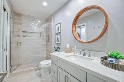 a bathroom with a sink and a toilet and a mirror at Seaside Sunset in Carlsbad