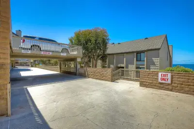 a building with a walkway with a sign that says buy only at Seaside Sunset in Carlsbad