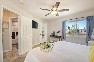 a bedroom with a bed and a ceiling fan at Silver Surf Getaway in Oceanside