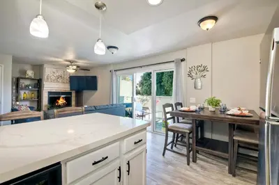 an open kitchen and dining room with a table and chairs at Silver Surf Getaway in Oceanside