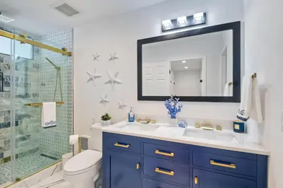 a bathroom with a sink and a shower with a mirror at Solana Sunset - Stunning Beachside Retreat for 4 in Solana Beach