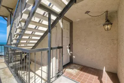 an empty porch with a staircase and a door at Solana Sunset - Stunning Beachside Retreat for 4 in Solana Beach