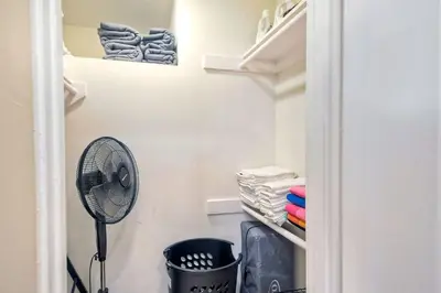 a closet with a fan and some towels at Southern Exposure with Private Balcony in Carlsbad