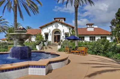 a house with a fountain in front of a house at Southern Exposure with Private Balcony in Carlsbad