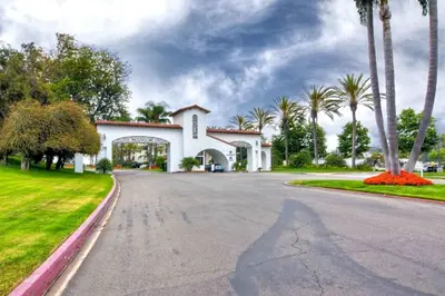 a white house with palm trees on a street at Southern Exposure with Private Balcony in Carlsbad