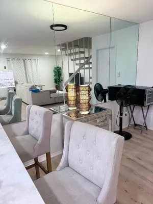 a living room with a couch and chairs and a mirror at Amazing House in La Jolla, CA in San Diego