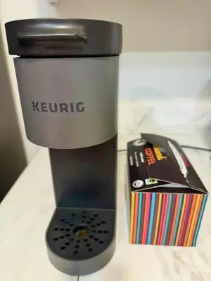 a coffee maker and a remote control on a counter at Amazing House in La Jolla, CA in San Diego