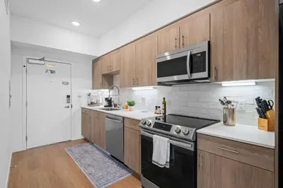 a kitchen with a stove and a microwave at King Bed + Fire Pit | Top Floor w/ Epic Views in San Diego