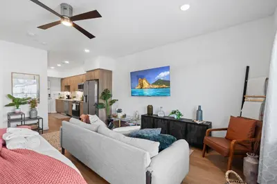 a living room with two couches and a ceiling fan at King Bed + Fire Pit | Top Floor w/ Epic Views in San Diego