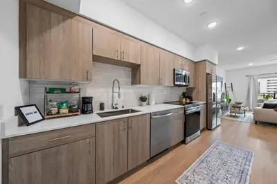 a kitchen with wooden cabinets and a counter top at King Bed + Fire Pit | Top Floor w/ Epic Views in San Diego