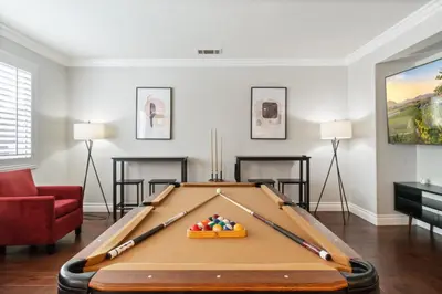a pool table in a living room with baseball bats at King Bed Temecula Getaway Amazing Pool and Theatre in Murrieta