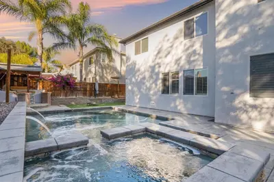 a swimming pool in front of a house at King Bed Temecula Getaway Amazing Pool and Theatre in Murrieta
