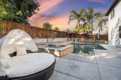 a backyard with a swimming pool and a chaise lounge at King Bed Temecula Getaway Amazing Pool and Theatre in Murrieta