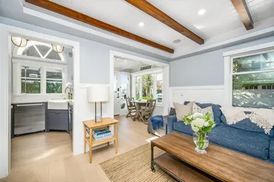 a living room with a blue couch and a table at Balboa Island Gem with Patio & Beach Essentials in Newport Beach