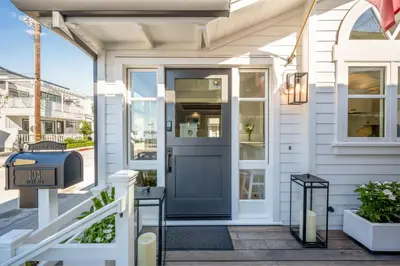 a front door of a white house with a blue door at Balboa Island Gem with Patio & Beach Essentials in Newport Beach
