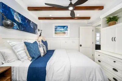 a bedroom with a bed with a ceiling fan at Balboa Island Gem with Patio & Beach Essentials in Newport Beach