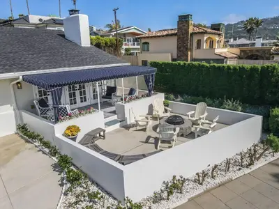 a backyard with a patio with a gazebo at Shores Luxury! Private Hot Tub, Fire Pit, Steps to Beach & Village Life in San Diego
