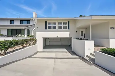 a large white house with a driveway at Shores Luxury! Private Hot Tub, Fire Pit, Steps to Beach & Village Life in San Diego