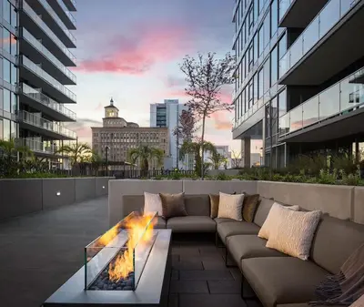 a patio with a couch and a fire pit at Penthouse High-Rise Ocean & City Views in San Diego