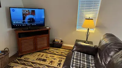 a living room with a couch and a flat screen tv at Julian Barn-Partment in Santa Ysabel