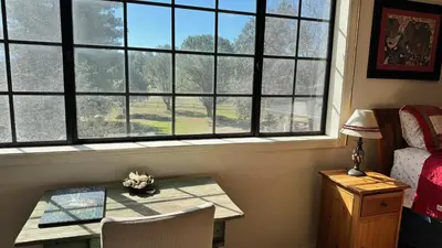 a room with a table and a window with a table and chairs at Julian Barn-Partment in Santa Ysabel